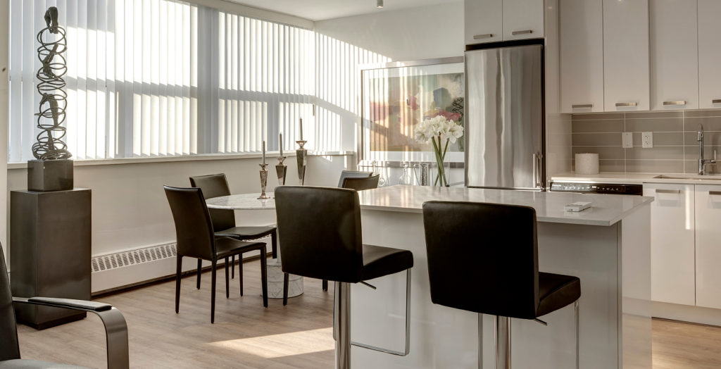 Elevated interior design in an 18 Brownlow renovated apartment, featuring a dedicated dining space and modern track lighting.