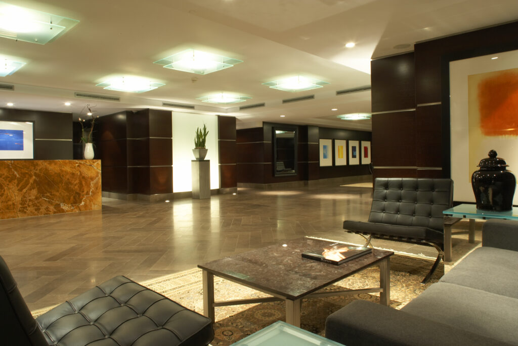 Sophisticated lobby featuring marble accents and designer lounge seating, professionally managed by The Benvenuto Group in Midtown Toronto.
